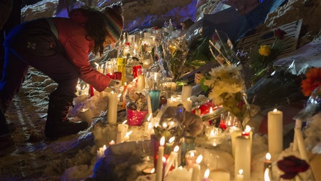 People placed candles at the vigil in Quebec City.
