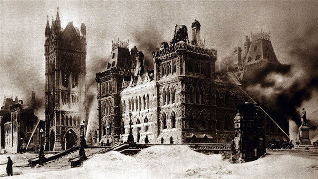 Pouring water on the fire and embers, presumably on Feb 4, as it is daylight and the top of the Victoria clock tower has collapsed as has several roof structures.