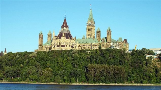July 2014-Rear view of Parliment viewed from Gatineau (Hull) across the Ottawa River.showing the original libary with the Victory and Peace tower rising above the rooftop