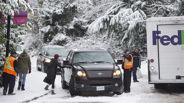 Vehicles got stuck on a small snow-covered hill in North Vancouver on Feb. 3, 2017.