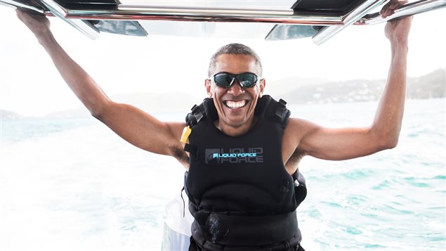 Obama sits on a boat during a kite surfing outing with British businessman Richard Branson during his holiday on Branson’s Moskito island, in the British Virgin Islands.