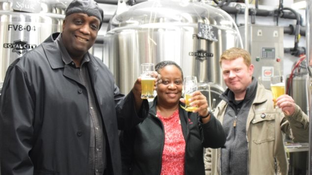 Celebrating Lantern Ale are, from the left, John Leacock and Denise Francis of the Guelph Black Heritage Society and Russell Bateman of Royal City Brewing Co.