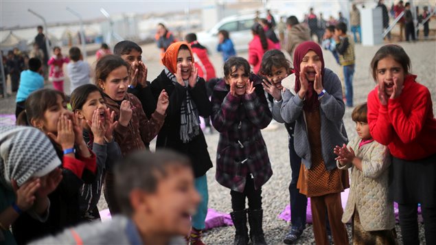 Displaced Iraqi girls sing outside tent schools set by United Nations Children’s Fund (UNICEF) at Hassan Sham camp, east of Mosul, Iraq December 8, 2016.