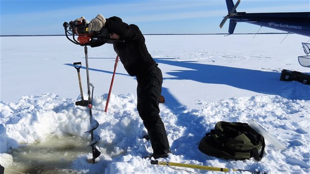Drilling through lake ice to retrieve a sediment core. Photo: Emily Stewart, Queen’s University