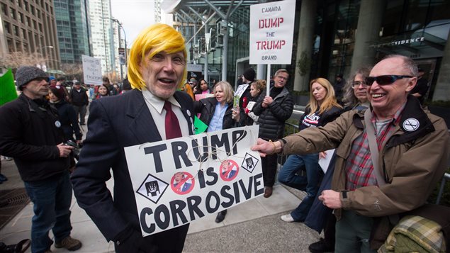 A man dressed as U.S. President Donald Trump jokes with protesters outside the official opening of the Trump International Hotel and Tower in Vancouver, B.C., on Tuesday February 28, 2017. U.S. President Donald Trump’s sons Donald Jr. and Eric attended the opening.