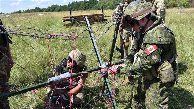 Canadian and Ukrainian Combat Engineers prepare explosive charges during obstacle demolition training at the International Peacekeeping and Security Centre in Starychi, Ukraine, on August 20, 2016