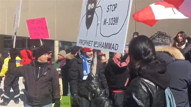 A small group opposed to M-103 was opposed and shouted down by a much larger group in a counter demonstration.