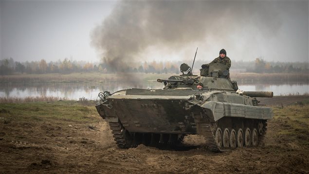 Starychi, Ukraine. 6 November 2015 – Ukrainian soldiers manoeuvre an armoured vehicle on a live range at the International Peacekeeping and Security Centre (IPSC) during Operation UNIFIER. 