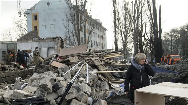 A woman speaks on her cell phone amonst the ruins of a building after shelling in Donetsk, eastern Ukraine, Friday, Feb. 3, 2017. Heavy shelling hit both government- and rebel-controlled areas. 