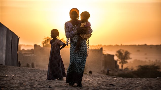 Amina carries her sister Zara in the town of Mao in Chad on Nov. 23, 2016.
