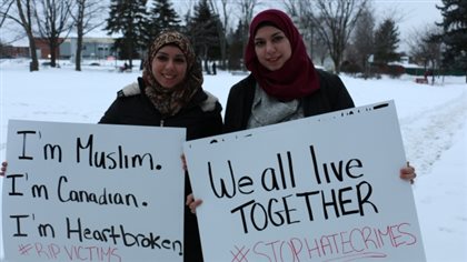 Sisters Mariam and Fatima Alaeddine brought signs of support to Memorial Park in Sudbury, ON on Tuesday, Jan. 31. The two were part of a public vigil in honour of the victims of the Quebec City mosque attack. MP Lightbound says he is proud of the way many young people responded to the attack.
