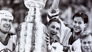 Edmonton fans are hoping for a return to the team's glory days in the 1980s--like this one, May 16, 1988, when Wayne Gretzky (2nd L), Mark Messier (L) and Kevin Lowe (2nd R) took the Stanley Cup from NHL President John Ziegler (R) after they defeated the Boston Bruins to win the NHL hockey championship.