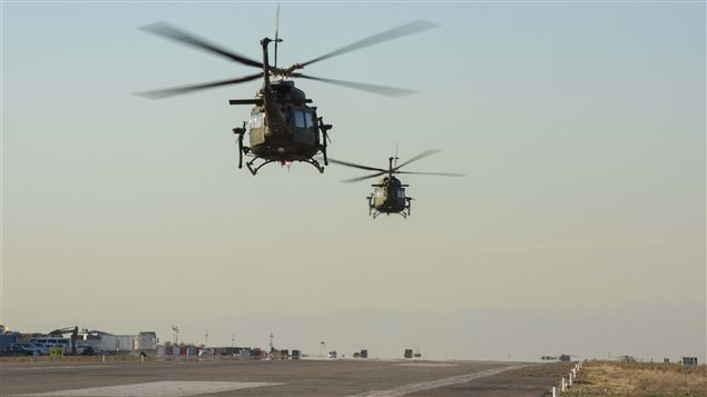 Two CH-146 Griffon helicopters take off from the flight line near Camp Érable, Iraq during Operation IMPACT on February 20, 2017.