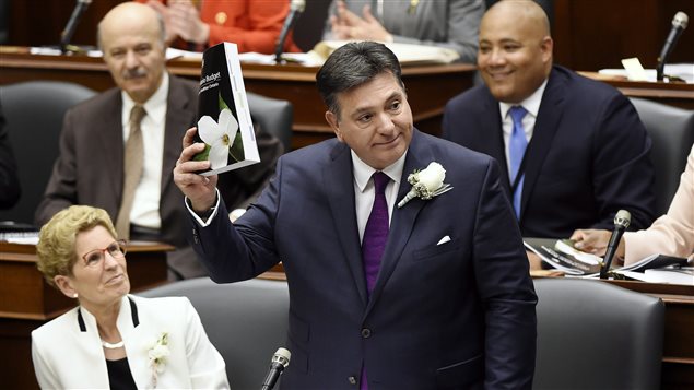Ontario Finance Minister Charles Sousa, right, delivers the 2017 Ontario budget next to Premier Kathleen Wynne at Queen’s Park in Toronto on Thursday, April 27, 2017. 