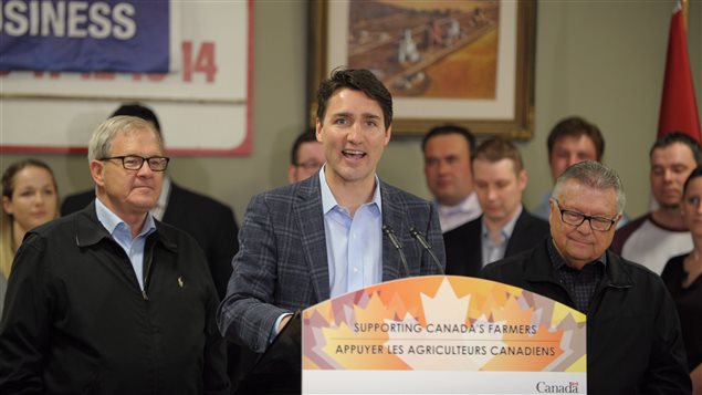 Prime Minister Justin Trudeau addresses locals and media at the Gray Recreation Centre in Gray, Sask., Thursday, April 27, 2017. Federal Agriculture and Agri-Food Minister Lawrence MacAulay (left) and Public Safety Minister Ralph Goodale (right) look on.