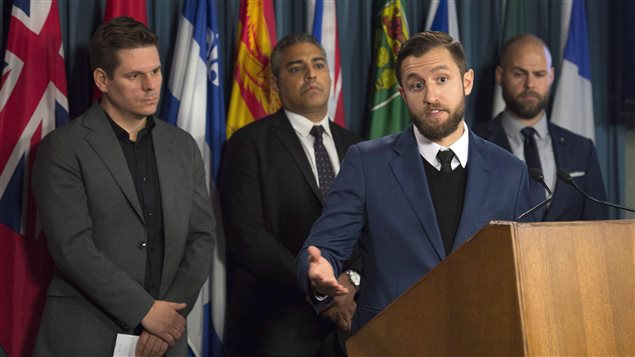 La Presse journalist Patrick Lagace (left), journalist Mohamed Fahmy, and Executive Director of Canadian Journalists for Free Expression Tom Henheffer (right) listen to VICE News journalist Ben Makuch speak about his experiences during a news conference on police surveillance and greater protection for journalists in Ottawa, Wednesday November 16, 2016.