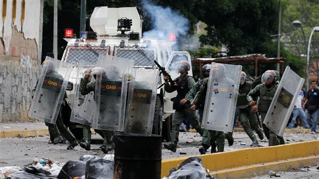 Venezuelan National guards fire tear gas toward opposition supporters during a protest against Venezuela’s President Nicolas Maduro’s government in Caracas, Venezuela May 2, 2017.