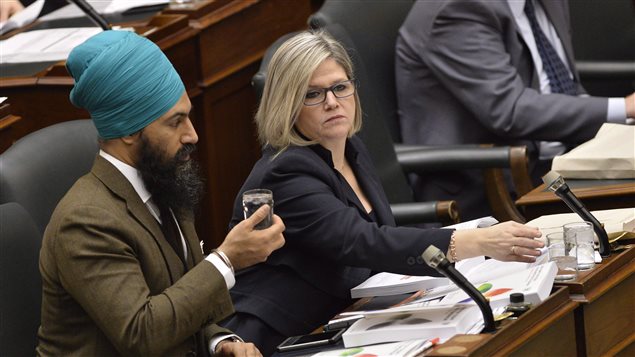 Ontario NDP Leader Andrea Horwath, right, talks with MPP Jagmeet Singh as Ontario Finance Minister Charles Sousa delivers the Ontario 2016 budget at Queen’s Park in Toronto on Thursday, February 25, 2016. 