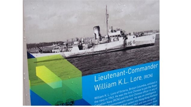 Lt Cmdr Lore’s history displayed on a panel in the promenade of a pier in Vancouver among several panels featuring historical moments in Canadian history