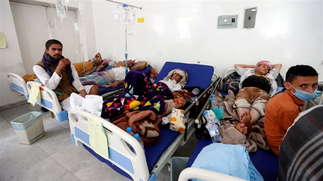 Yemeni men suspected of being infected with cholera receive treatment at a hospital in Sanaa on May 12, 2017.