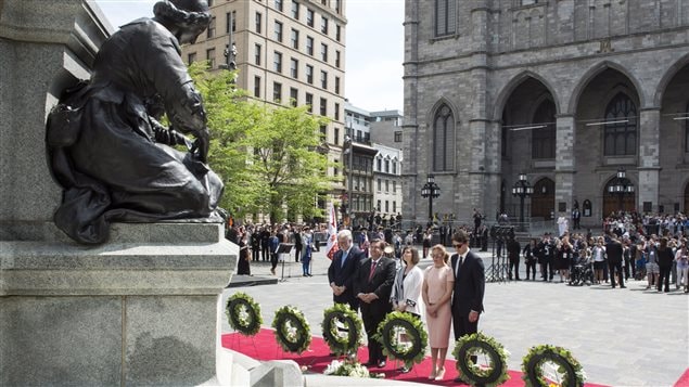 Prime Minister Justin Trudeau and Ms. Gregoire Trudeau, Premier of Quebec Philippe Couillard and Mayor Coderre and his wife Chantal Renaud pause after laying a wreath in front of a statue of Paul Chomedy de Maisonneuve, the founder of Montreal, during a ceremony marking the 375th anniversary of the founding of Montreal Wednesday, May 17, 2017 in Montreal. 