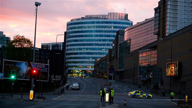 The sun rises as police stand guard outside the Manchester Arena in Manchester, Britain May 23, 2017. 