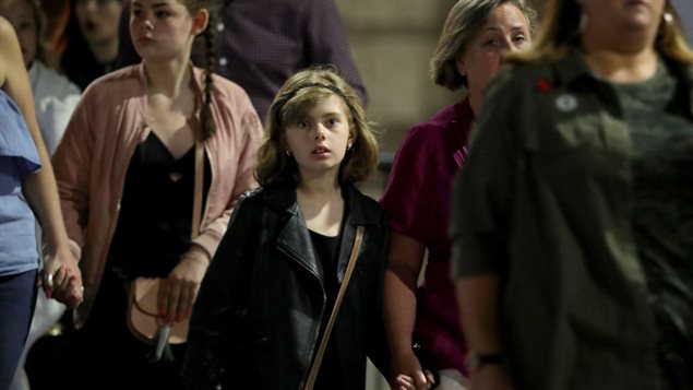 Police escort members of the public from the Manchester Arena on May 23, 2017 in Manchester, England. 