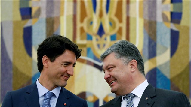 Ukraine’s President Petro Poroshenko talks with Canada’s Prime Minister Justin Trudeau during a signing ceremony in Kiev, Ukraine, July 11, 2016. 