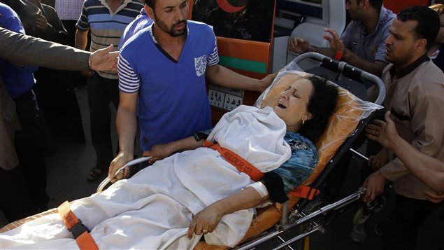 A woman wounded in an attack on Coptic Christians arrives at Nasser Institute Hospital in Cairo, Egypt, Friday, May 26, 2017. Egyptian officials say dozens of people have been killed and wounded in an attack by masked gunmen on a bus carrying Coptic Christians south of Cairo. The attack happened while the bus was on its way to a monastery. There has been no immediate claim of responsibility, but the attack bore the hallmarks of the Islamic State affiliate in Egypt. 
