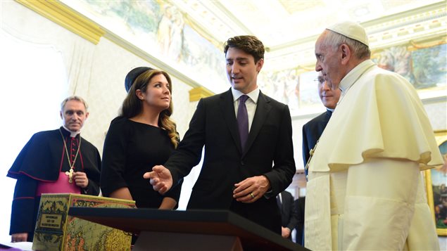 Prime Minister Justin Trudeau presents a gift with wife Sophie Gregoire Trudeau meet with Pope Francis for a private audience at the Vatican on Monday, May 29, 2017. 