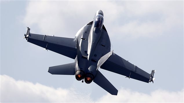 A Boeing F/A-18 E/F Super Hornet flies on display during Farnborough International Air Show, Farnborough, England, Tuesday, July 15, 2014. 