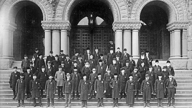 Fenian Raids veterans in front of the Ontario Legislative building in Queen’s Park, 1900. This is possibly after they were awarded medals which they all seem to be wearing.