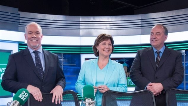 (L-R) B.C. NDP leader John Horgan, Liberal Leader Christy Clark and B.C. Green Party leader Andrew Weaver pose for a photo following the leaders debate in Vancouver, B.C., Thursday, April 20, 2017. The Liberals won the May election with a slim majority of seats, but NDP and Greens have formed a coalition which would give them one seat more than the Liberals.