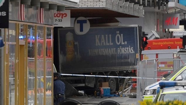 The rear of a truck, left, protrudes from a department store in central Stockholm, Sweden, on April 7, this year after plowing down the street killing four people and injuring 15. 