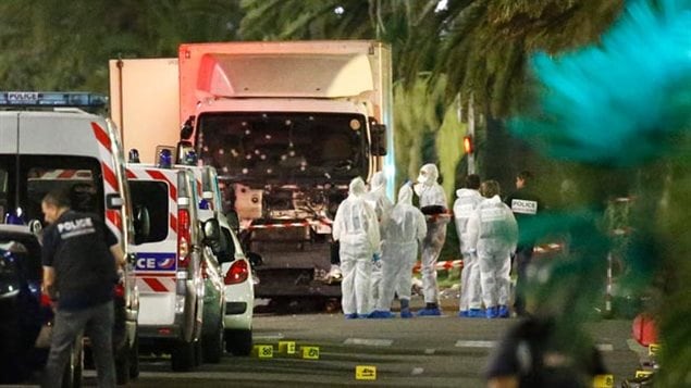 Forensic experts examine the bullet-riddled truck driven by a radical that drove into a crowd in Nice France on Bastille Day 2016, killing dozens.