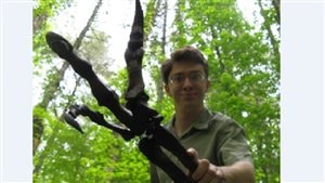 Paleontoltogist Scott Persons PhD (holding a recreated fore-arm of an Allosaurus)