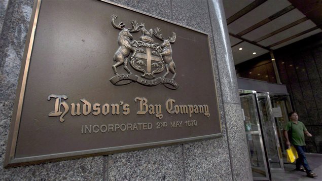 A Hudson’s Bay Co. store sign is shown at its Toronto flagship store on July 29, 2013. Hudson’s Bay Co. says it is cutting 2,000 jobs, including some it says were previously announced in February. 