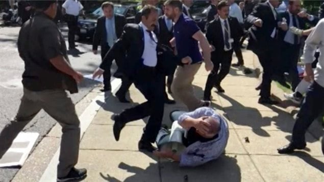 In this image from video provided by Voice of America, members of Turkish President Recep Tayyip Erdogan’s security detail are shown violently reacting to peaceful protesters during Erdogan’s trip last month to Washington. (Voice of America/Associated Press)