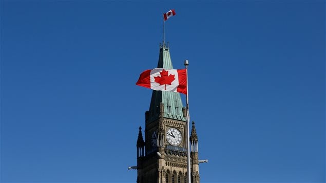 A Canadian flag flies in front of the Peace Tower on Parliament Hill in Ottawa, Ontario, Canada, March 22, 2017. 