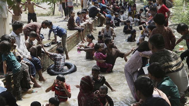 On June 4, 2017 families cooled off in a stream in Lahore, Pakistan. 