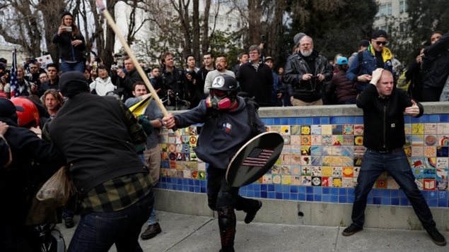 March 04. 2017: A demonstrator in support of U.S. President Donald Trump swings a stick toward a group of counter-protesters during a rally in Berkeley, Calif., 