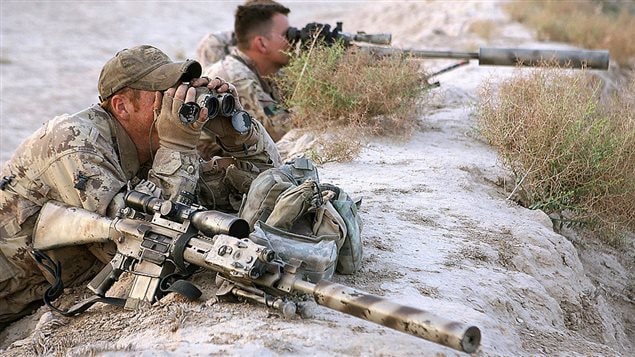  A Canadian sniper team scan the landscape during an Afghan-led operation to arrest suspected Taliban operating in the Panjwayi district of southern Kandahar province, supported by Coalition forces, 28 April 2006.