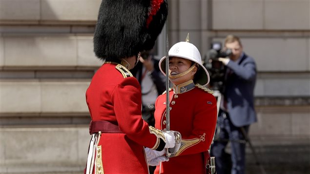 Canadian Captain Megan Couto, right, makes history by becoming the first female Captain of the Queen’s Guard as she takes part in the Changing the Guard ceremony at Buckingham Palace in London, Monday, June 26, 2017.