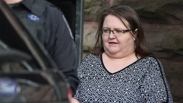 Elizabeth Wettlaufer is escorted by police from the courthouse in Woodstock, Ont, Monday, June 26, 2017. Wettlaufer, a former Ontario nurse who murdered eight seniors in her care, was sentenced Monday to life in prison with no eligibility for parole for 25 years.