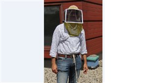 York University professor Amro Zayed on the unversity rooftop apiary.
