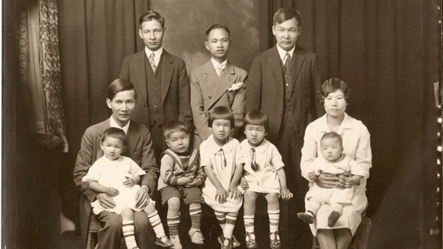 One story remembers Yee Clun (seated front row with family), a restaurateur who challenged a law forbidding Chinese men from hiring white women.