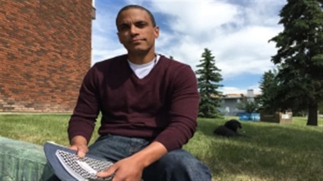 Matthew Hamm with the journals he wrote in while in solitary confinement for 43 days at the Edmonton Institution from June 30, 2016 to Aug. 10, 2016. 