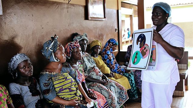 Blandine Mekpo, a midwife at a maternity ward, provides information about AIDS to pregnant women in Bohicon in southern Benin on November 29, 2016.