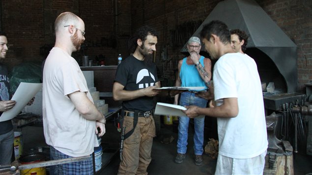 Master Japanese swordsmith Fusataro (R) presents Montreal-based blacksmith Ivan Savchev with his certificate of completion of a recent blade-making workshop at Les Forges de Montreal. 