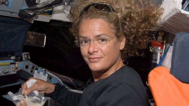 Canadian Space Agency astronaut Julie Payette, STS-127 mission specialist, eats a meal on Space Shuttle Endeavor’s flight deck during flight day 3, on Friday July 17, 2009. 